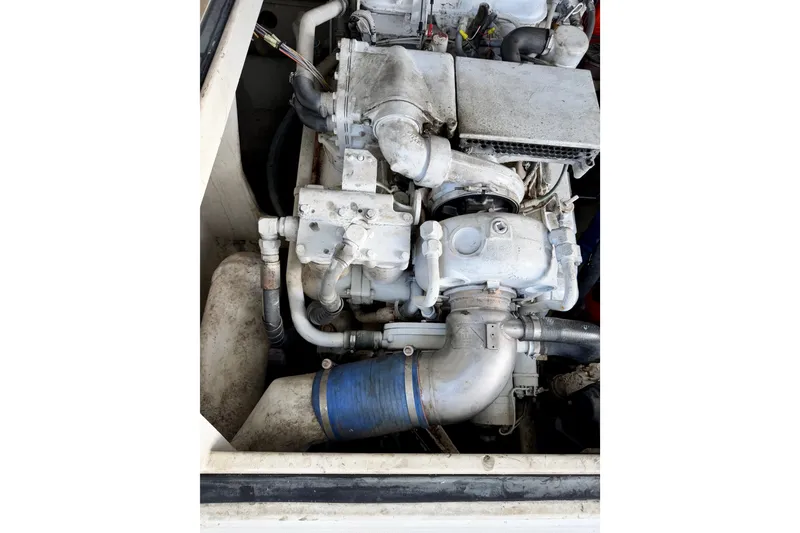 Slide: The Image of Engine compartment of a 1995 Cabo 35 Express boat, showcasing mechanical components. - 37