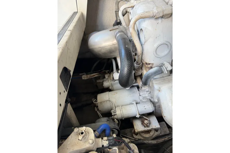 Slide: The Image of Engine compartment of a 1995 Cabo 35 Express boat, showcasing hoses and components. - 38