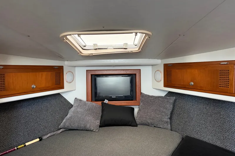 Slide: The Image of Interior cabin of a 1995 Cabo 35 Express boat with cozy bedding and wooden storage. - 23