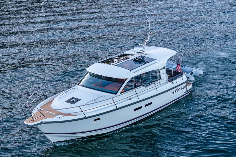 Slide: The Image of 2024 Nimbus 365 Coupe cruising on water, showcasing sleek design and modern features. - 43