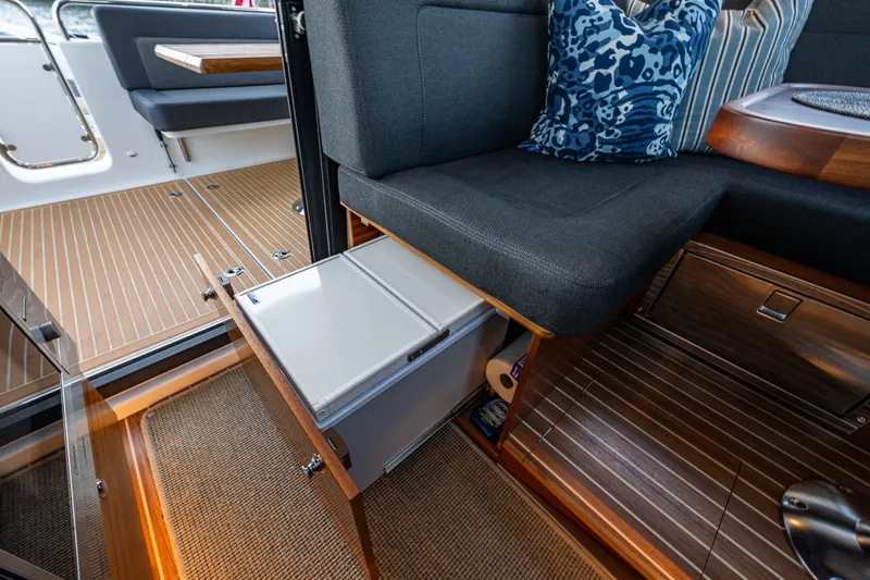 Slide: The Image of 2024 Nimbus 365 Coupe interior with sleek seating and hidden storage. - 13