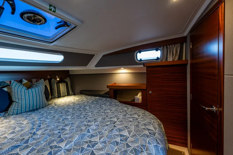 Slide: The Image of Luxurious cabin interior of 2024 Nimbus 365 Coupe with skylight and elegant bedding. - 19