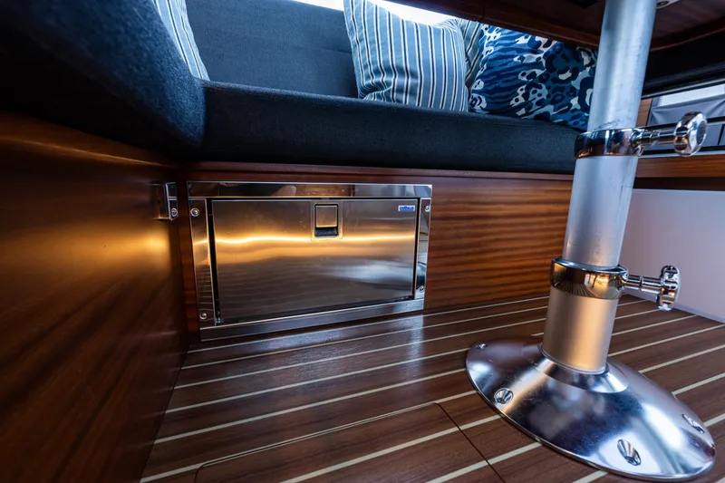 Slide: The Image of Interior of 2024 Nimbus 365 Coupe showcasing sleek wood finish and modern seating. - 12