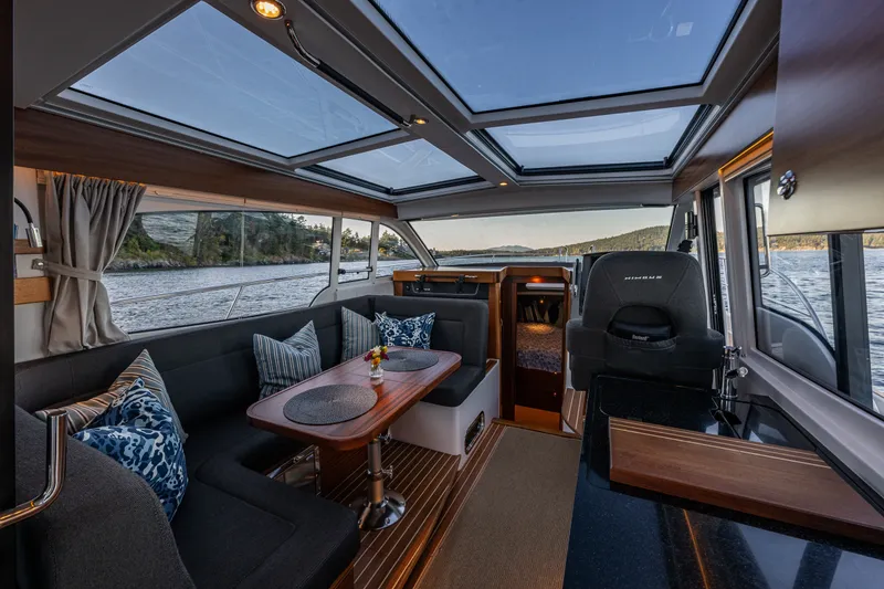 Slide: The Image of Interior of 2024 Nimbus 365 Coupe yacht with elegant seating and panoramic windows. - 4