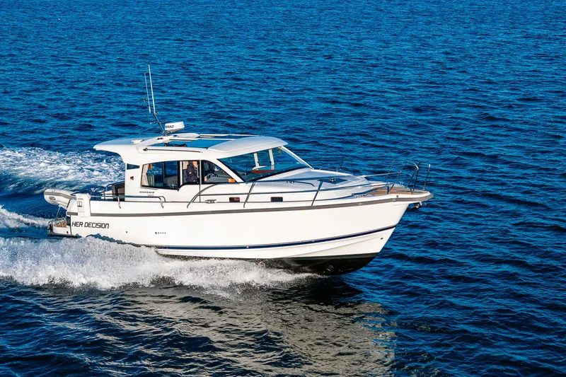 Slide: The Image of 2024 Nimbus 365 Coupe cruising on open water, showcasing sleek design and performance. - 31