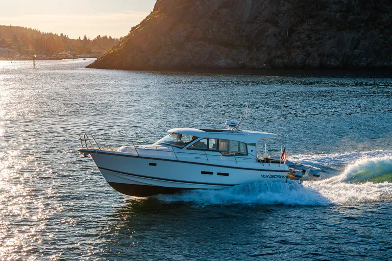 Slide: The Image of 2024 Nimbus 365 Coupe cruising on scenic waterway at sunset. - 29