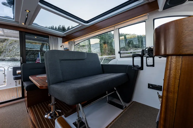 Slide: The Image of Interior of 2024 Nimbus 365 Coupe boat with modern seating and panoramic windows. - 7