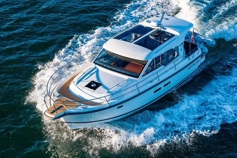 Slide: The Image of 2024 Nimbus 365 Coupe cruising on open water, showcasing sleek design and performance. - 34