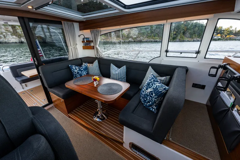 Slide: The Image of Luxurious interior of 2024 Nimbus 365 Coupe yacht with elegant seating and scenic water view. - 6