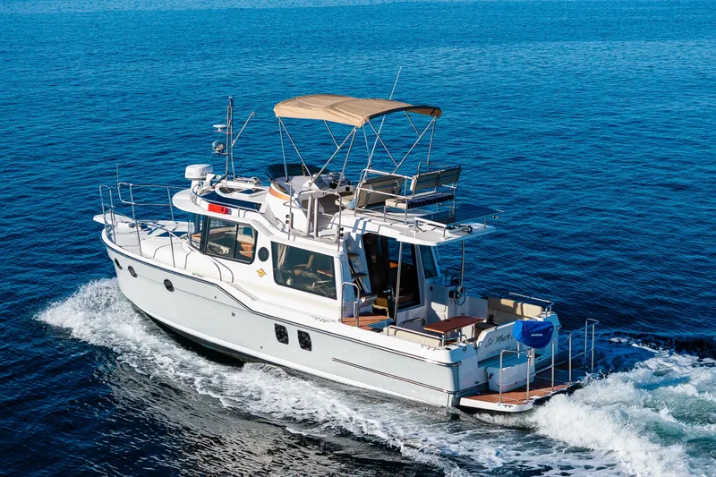Slide: The Image of 2023 Ranger Tugs R-29 CB cruising on open blue water. - 45