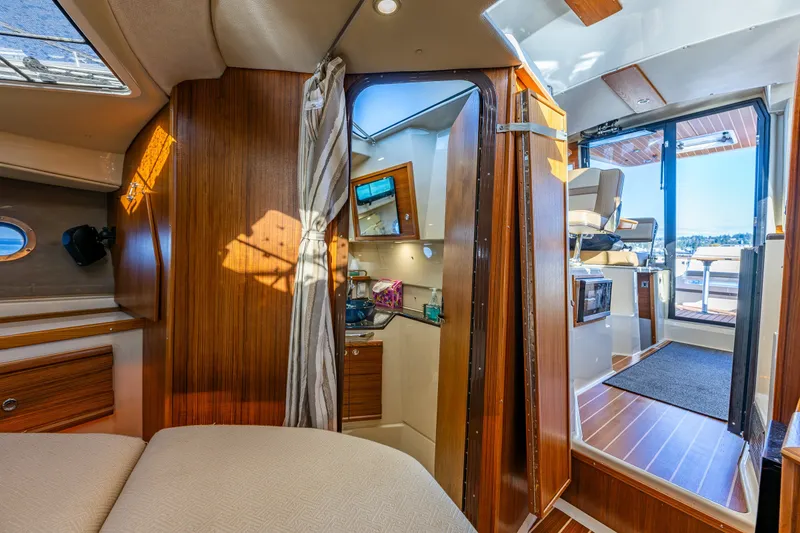 Slide: The Image of Interior of 2023 Ranger Tugs R-29 CB, featuring wood finishes and modern amenities. - 13