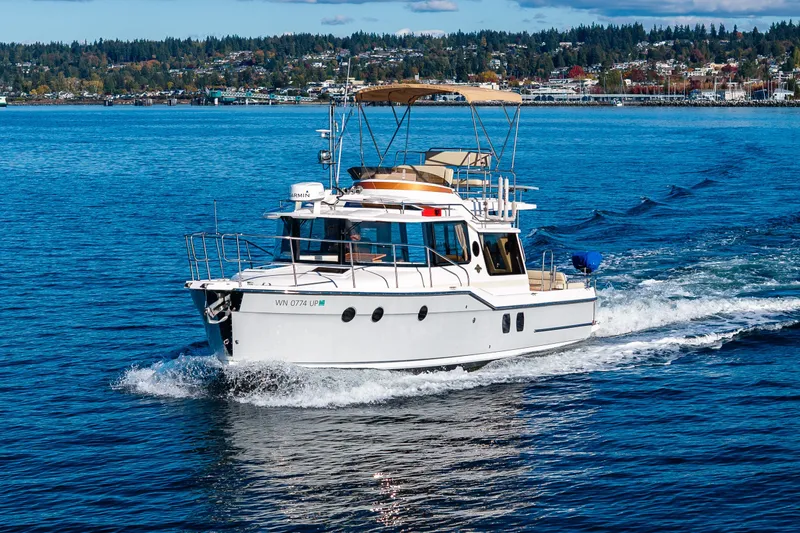 Slide: The Image of 2023 Ranger Tugs R-29 CB cruising on a scenic blue lake. - 46