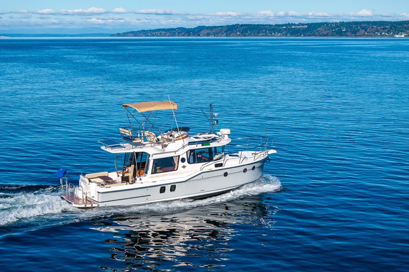 Slide: The Image of 2023 Ranger Tugs R-29 CB cruising on open blue water. - 58