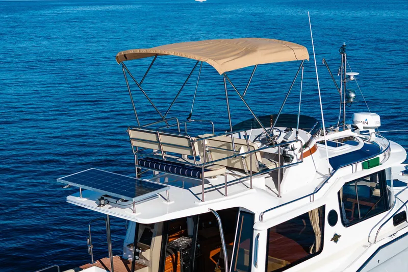 Slide: The Image of 2023 Ranger Tugs R-29 CB boat with canopy and solar panel on blue water. - 52