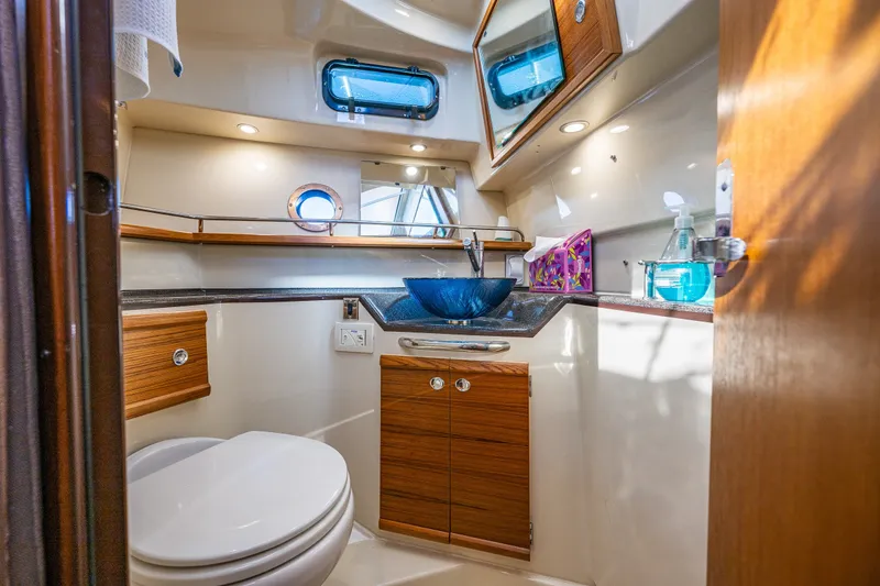 Slide: The Image of Luxurious 2023 Ranger Tugs R-29 CB bathroom with modern fixtures and elegant wood cabinetry. - 15