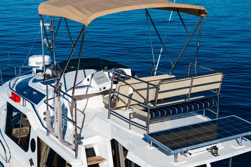 Slide: The Image of 2023 Ranger Tugs R-29 CB boat with canopy and solar panel on calm water. - 27