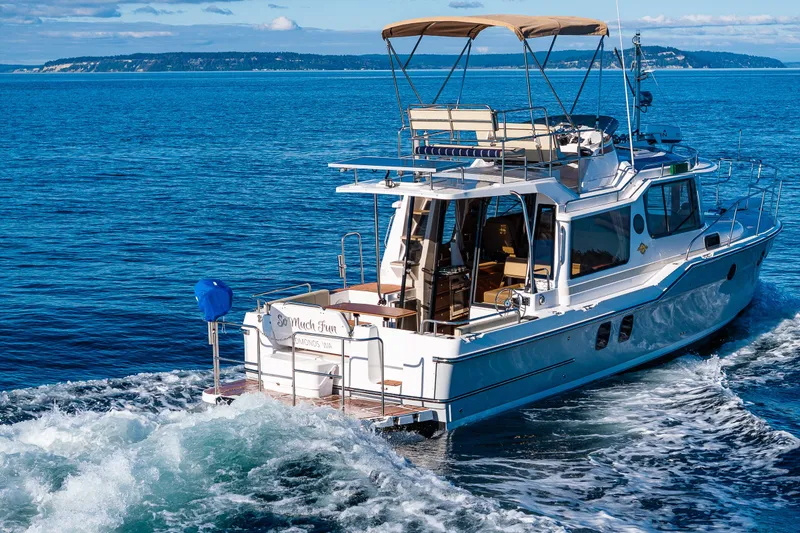 Slide: The Image of 2023 Ranger Tugs R-29 CB cruising on open blue water. - 51