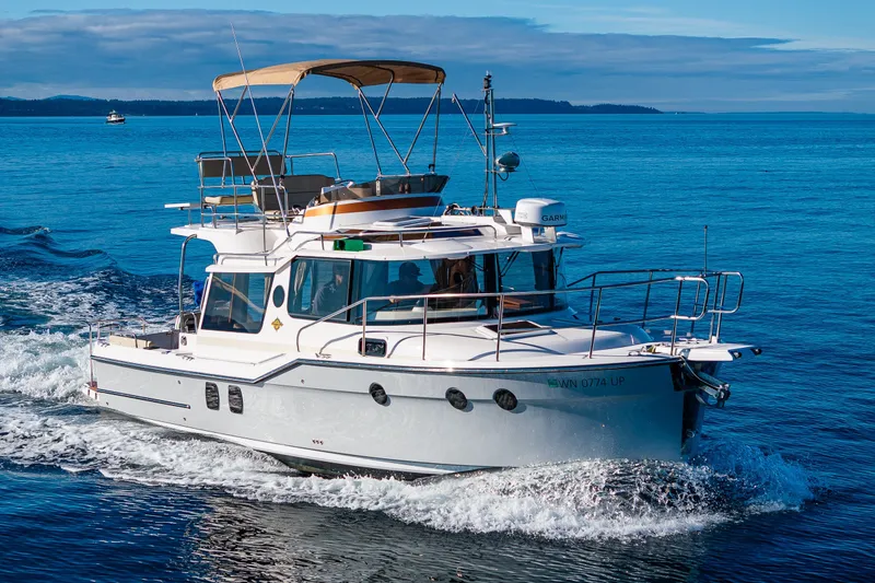 The Image of 2023 Ranger Tugs R-29 CB cruising on a clear blue sea. - 0