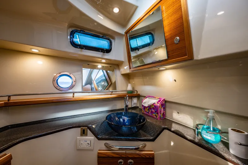 Slide: The Image of Luxurious bathroom interior of 2023 Ranger Tugs R-29 CB with modern fixtures and elegant design. - 16