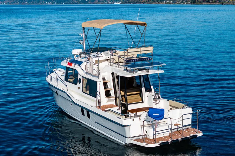 Slide: The Image of 2023 Ranger Tugs R-29 CB cruising on calm blue waters. - 33