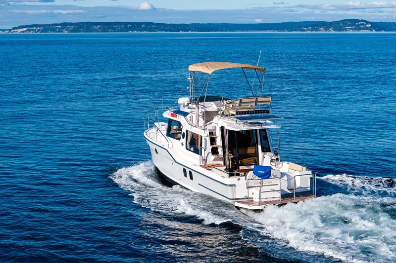 Slide: The Image of 2023 Ranger Tugs R-29 CB cruising on open blue water. - 50