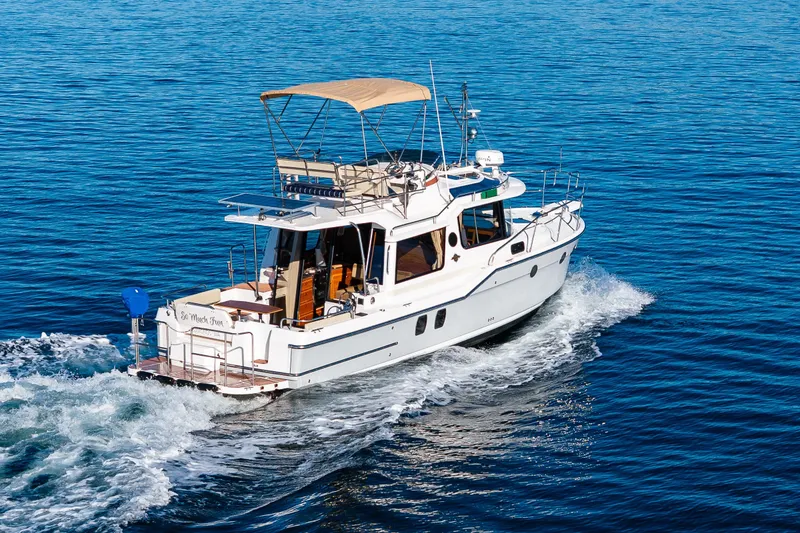 Slide: The Image of 2023 Ranger Tugs R-29 CB cruising on open water, showcasing sleek design and performance. - 56