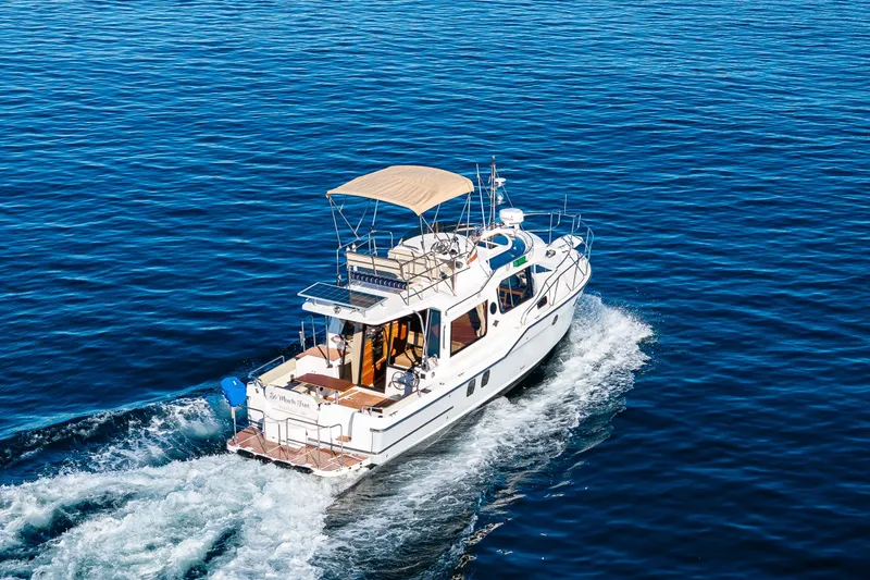 Slide: The Image of 2023 Ranger Tugs R-29 CB cruising on open blue water. - 54
