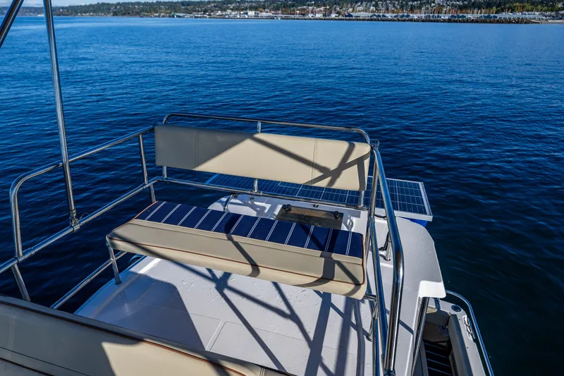 Slide: The Image of 2023 Ranger Tugs R-29 CB boat deck with seating, overlooking calm blue water. - 26
