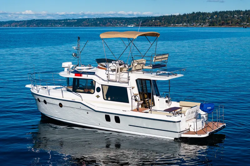 Slide: The Image of 2023 Ranger Tugs R-29 CB cruising on a serene blue lake. - 40