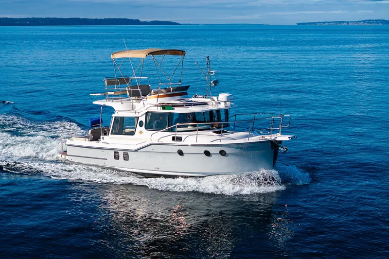 Slide: The Image of 2023 Ranger Tugs R-29 CB cruising on open blue water. - 59