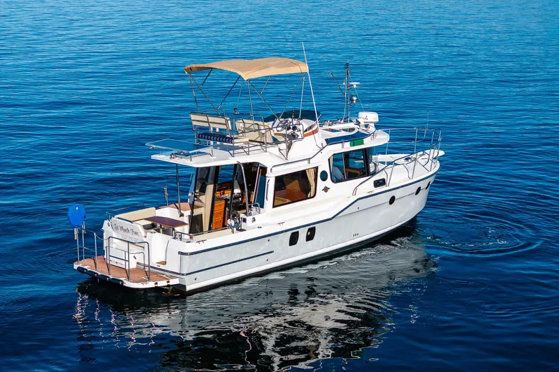 Slide: The Image of 2023 Ranger Tugs R-29 CB cruising on calm blue waters. - 38