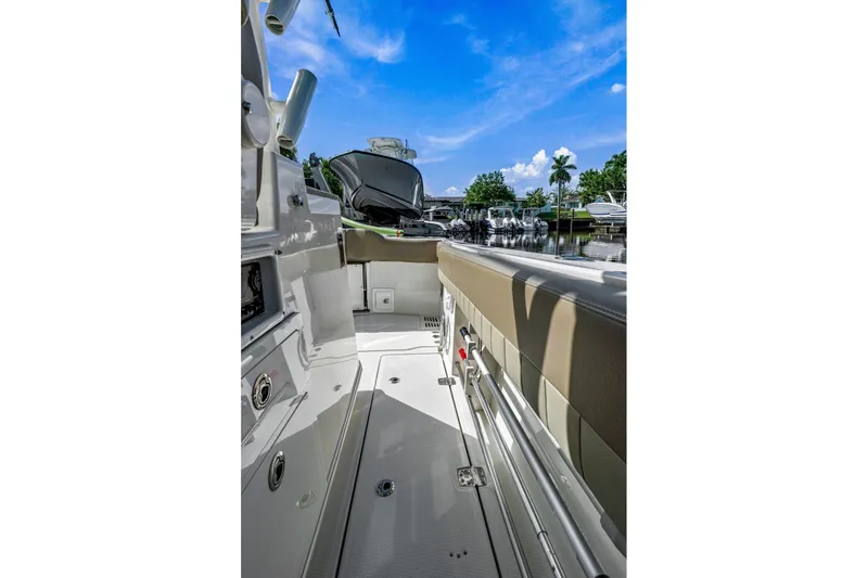 Slide: The Image of 2019 Sailfish 360 CC boat interior with sleek design, docked under a clear blue sky. - 14