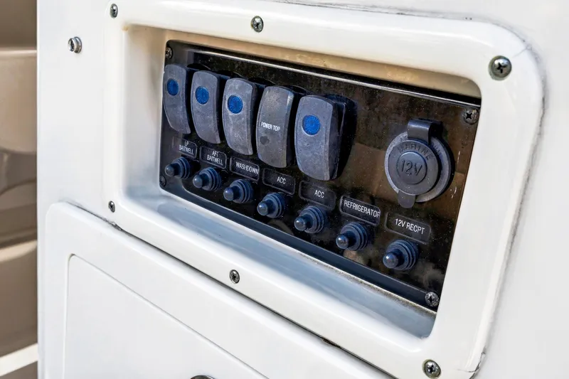 Slide: The Image of Control panel of a 2019 Sailfish 360 CC boat with switches and 12V outlet. - 40