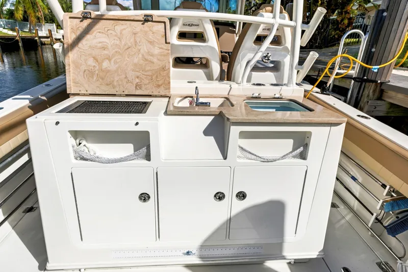 Slide: The Image of 2019 Sailfish 360 CC boat with onboard sink and storage compartments. - 22