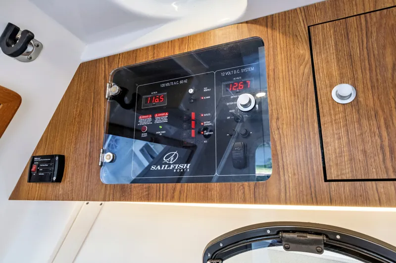 Slide: The Image of Control panel of a 2019 Sailfish 360 CC boat, featuring voltage displays and switches. - 38