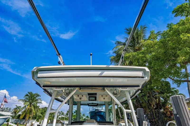Slide: The Image of 2019 Sailfish 360 CC boat with T-top, surrounded by palm trees and blue sky. - 26