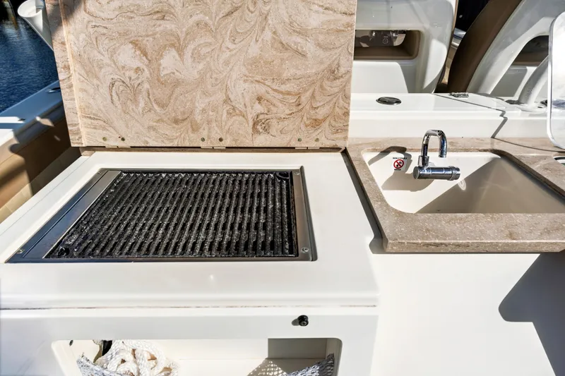 Slide: The Image of Outdoor kitchen on 2019 Sailfish 360 CC boat with grill and sink. - 23