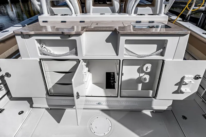 Slide: The Image of 2019 Sailfish 360 CC boat interior with open storage compartments and countertop. - 21