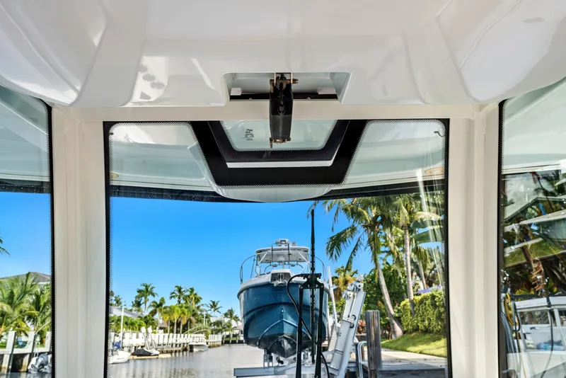 Slide: The Image of Interior view of 2019 Sailfish 360 CC boat with marina and palm trees outside. - 30