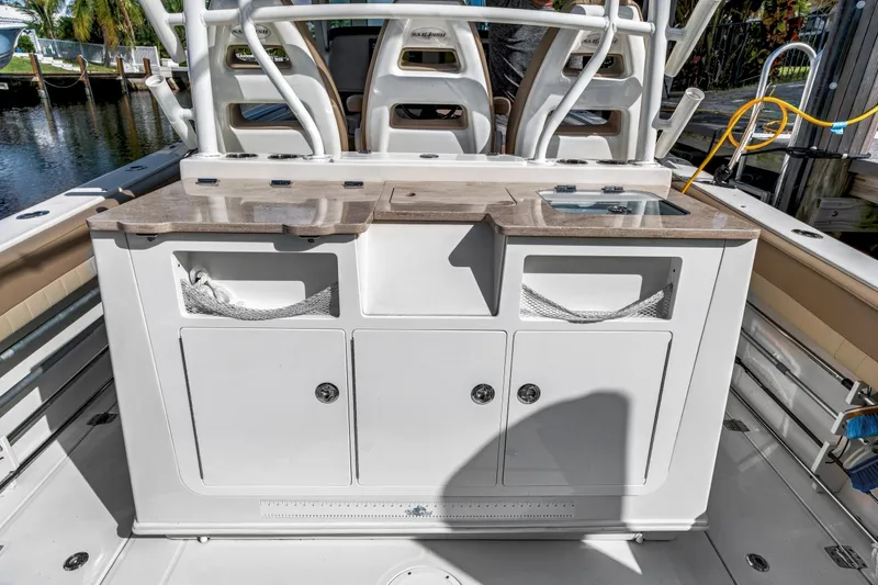 Slide: The Image of 2019 Sailfish 360 CC boat interior with dual sinks and storage compartments. - 20