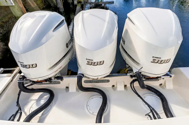Slide: The Image of Triple Yamaha 300 engines on a 2019 Sailfish 360 CC boat, docked by water. - 19