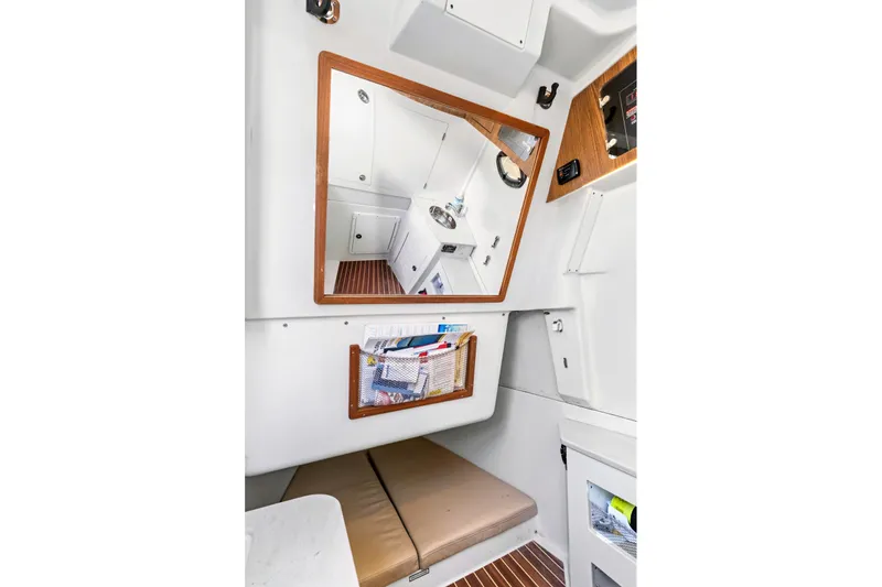 Slide: The Image of Interior of 2019 Sailfish 360 CC boat with mirror and storage compartments. - 37