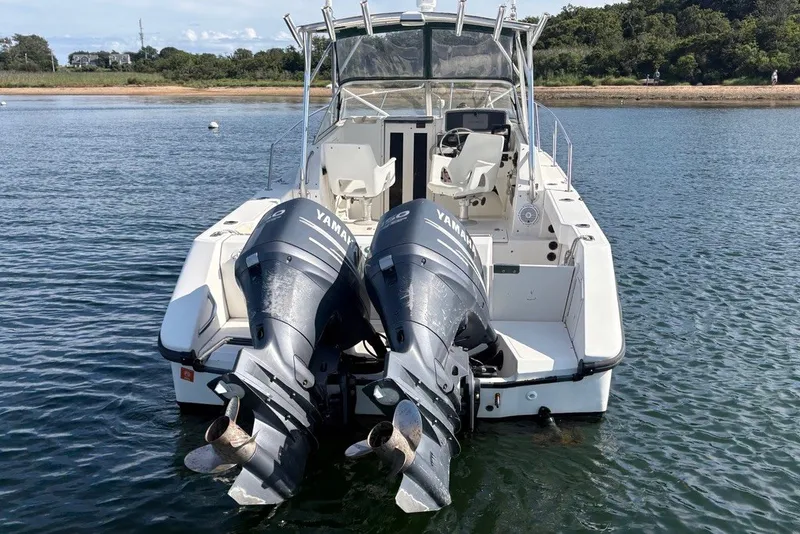 Slide: The Image of 1998 Boston Whaler 235 Conquest with dual Yamaha outboard motors on calm water. - 5