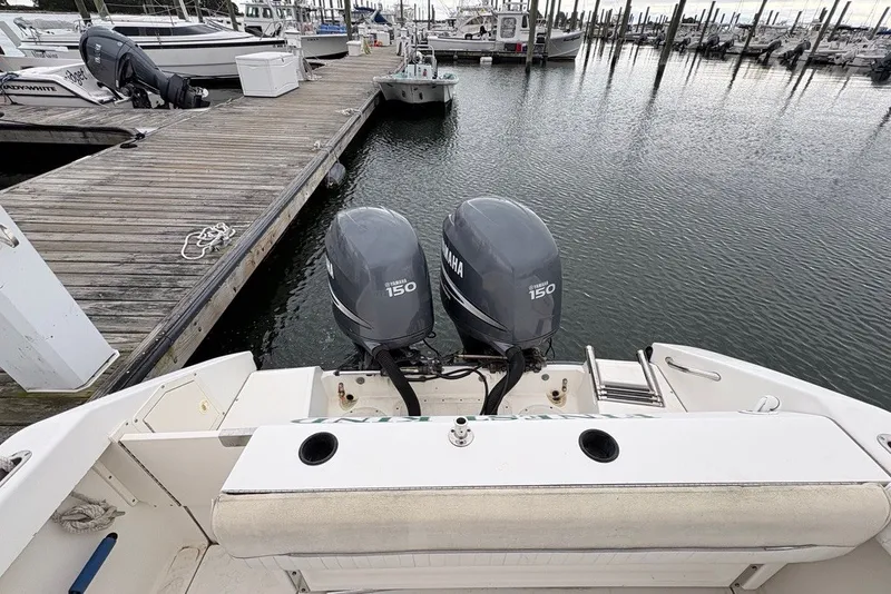 Slide: The Image of Boston Whaler 235 Conquest 1998 with twin Yamaha 150 engines docked at marina. - 7