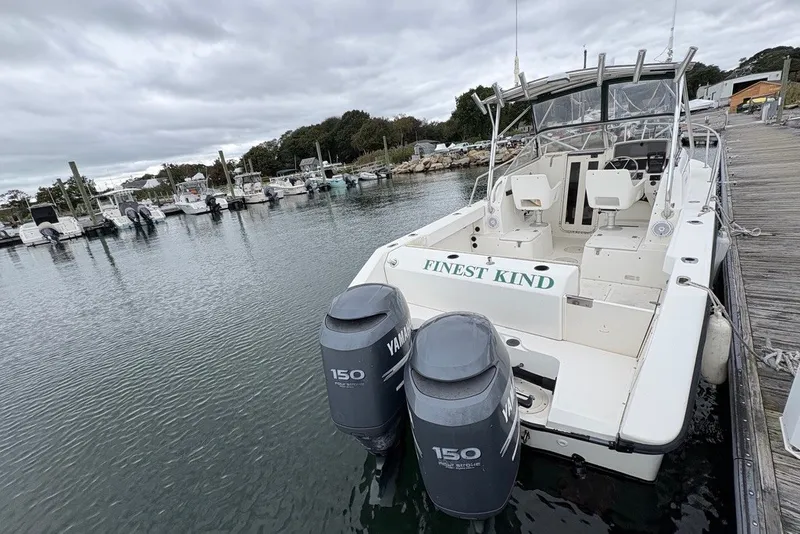 Slide: The Image of Boston Whaler 235 Conquest 1998 boat docked with twin Yamaha 150 engines. - 6
