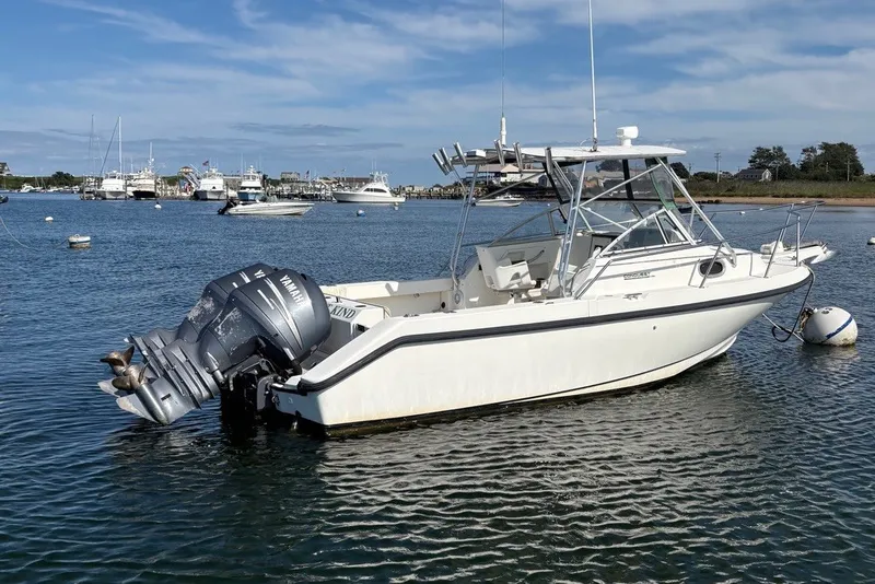 Slide: The Image of 1998 Boston Whaler 235 Conquest boat moored in a calm harbor. - 2