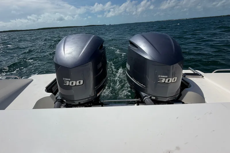 Slide: The Image of Twin Yamaha 300 engines on a 2017 Pursuit OS 325 Offshore boat in open water. - 14