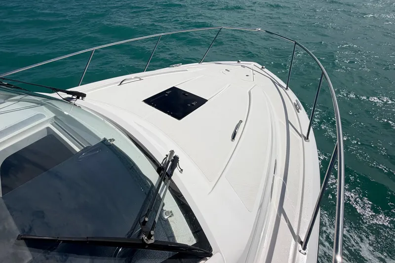 Slide: The Image of 2017 Pursuit OS 325 Offshore boat cruising on clear blue water. - 50
