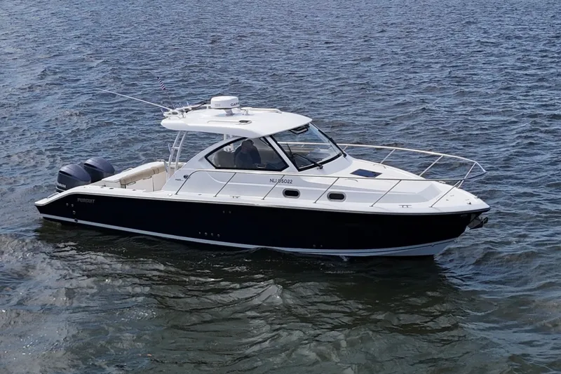 Slide: The Image of 2017 Pursuit OS 325 Offshore boat cruising on open water. - 3