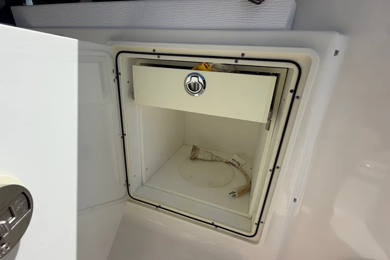 Slide: The Image of Open storage compartment on a 2017 Pursuit OS 325 Offshore boat. - 21